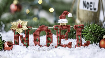 Beaded 'NOEL' Christmas decoration with festive ornaments and snowy background