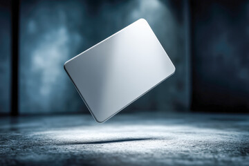 Minimalist contactless payment card floating above dark surface with dramatic shadow and negative space