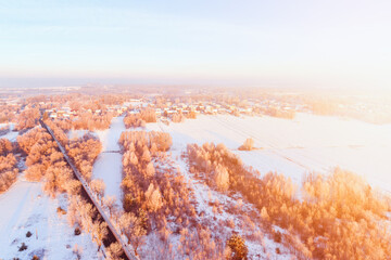 Stunning winter landscape with golden sun rays