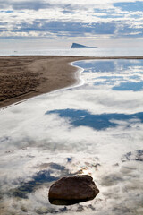 Cloud Reflection and Lone Rock on Benidorm Beach