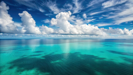 Immersive aerial journey. Aerial view of calm tropical waters with vibrant blue sky and fluffy clouds