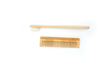 Natural Wooden Toothbrush and Comb on White Background