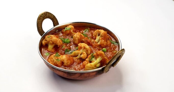 indian spicy food Gobi Masala or gobi fry or cauliflower curry with green peas, served in a bowl, selective focus