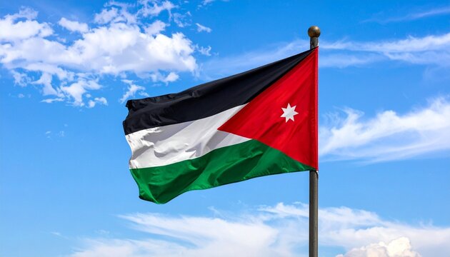 National flag of Jordan flying on flagpole against blue sky with wispy white clouds.