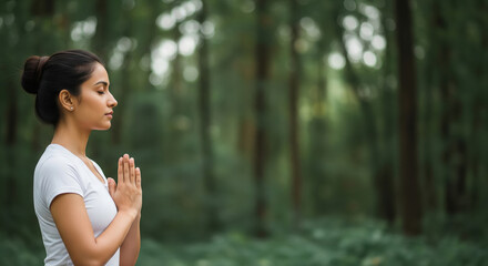 Young woman meditating outdoors in serene forest with closed eyes