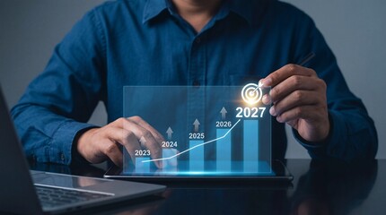 A businessman interacts with a transparent digital display showing a rising graph and future projections representing strategic planning and innovative technology