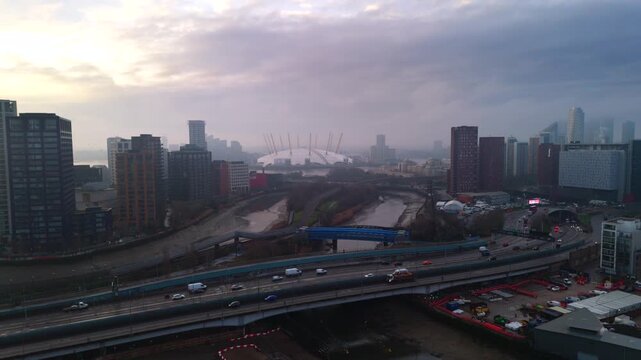 Drone shot Greenwich Peninsula and Poplar in East London. Morning sunrise over outskirts of urban city