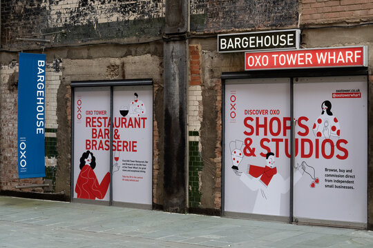 LONDON, UK - NOVEMBER 12, 2025:  Advertising signs for shops and restaurants at Bargehouse, Oxo Tower wharf