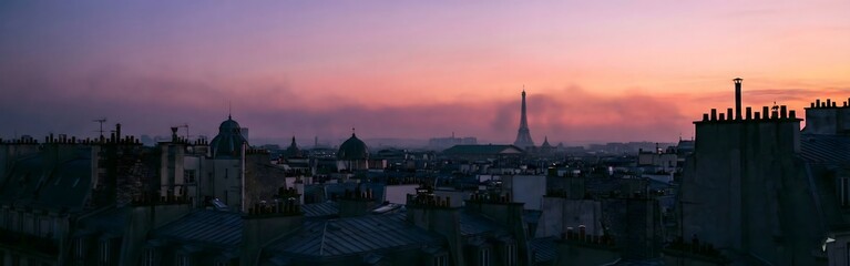 Fototapeta premium Eiffel Tower Sunset over Parisian Rooftops