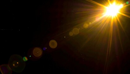 Bright sun flare with rays and reflections against a black background