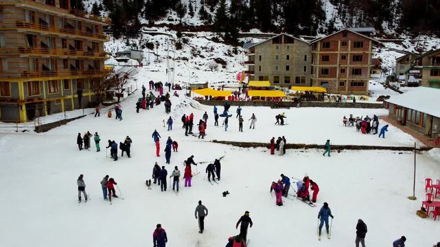 Drone View of Solang Village with Tourists Skiing After Snowfall in manali himachal pradesh india 