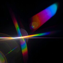 Lens flare creating vibrant rainbow streaks and circular glows on black