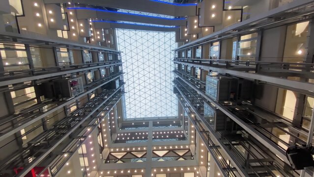 Modern building atrium with glass elevators moving up
