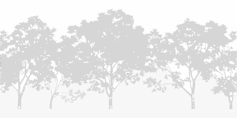 A grayscale silhouette of several trees against a light blurred background © Sudhakar