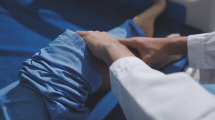 Asian physical therapist nurse is performing physical therapy to rehabilitate the legs of an elderly female patient.