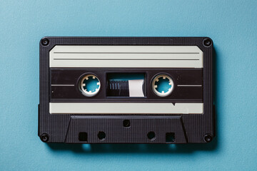 Fototapeta premium Vintage cassette tape on blue background nostalgic music