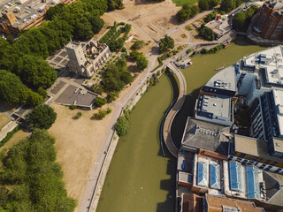 Bristol England: 28th Jul 2025: Scenic topdown drone view of Bristol Castle Park along the Feeder canal to river Avon. St Peter's Church Bristol with city skyline backdrop