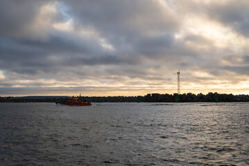 Peaceful ocean sunset scene with concrete breakwaters and buoys, evoking serenity and tranquility