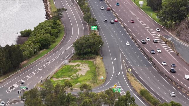 Close tele view of heavy motor vehicles traffic on Motorway one crossing Hawkesbury river.