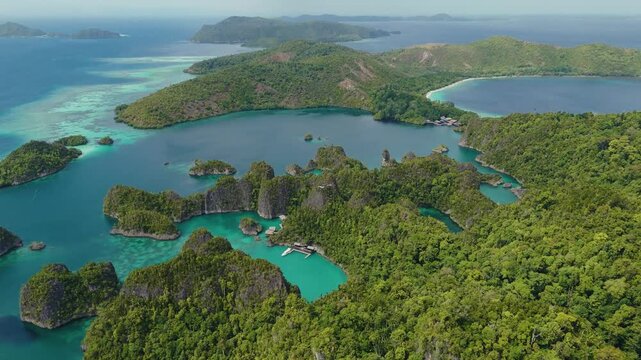 Raja Ampat, Indonesia: Aerial drone footage of the famous Piaynemo viewpoint plateform overlooking a stunning lagoon in the Fam islands in Raja Ampat in west Papua in Indonesia.