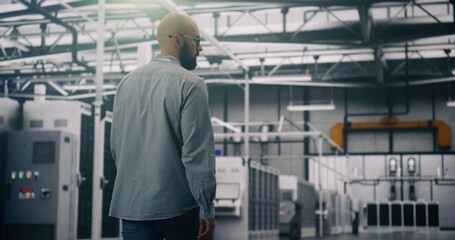 Security Oversight, Data Center Specialist Monitoring Access and Safety. Specialist Walking and Monitoring Security, Access Within Glowing Server Room. Concept Data Security and Facility Surveillance.