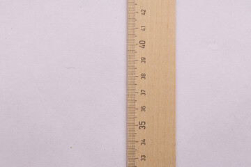 School wooden long ruler on a light background