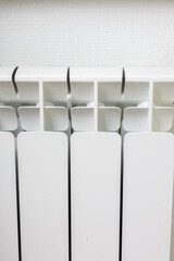White sectional bimetallic radiator on the wall