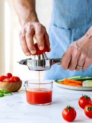 Fresh Tomato Juice Being Extracted with a Manual Juicer