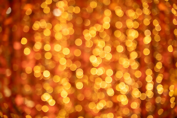 Out of focus golden bokeh circles on warm neutral background