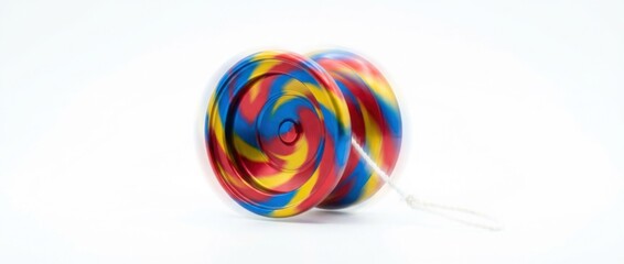 yoyo in motion captured mid-air with sharp focus on the spinning toy highlighting smooth curves and bright colors against a clean minimal white studio backdrop