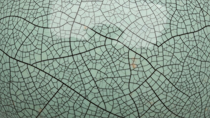Naklejka premium Seamless Hyper-Realistic Cracked Glaze Celadon Ceramic Texture Pattern with Elegant Crazing on Pale Sea-Foam Green