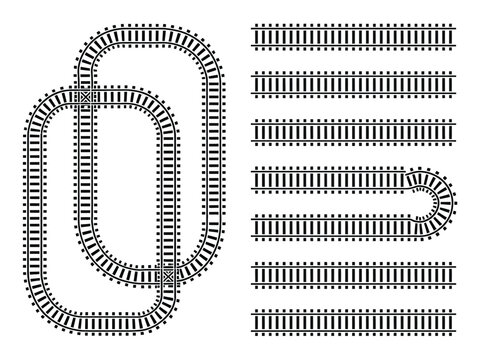 An assortment of model train tracks, including curves and straight sections.