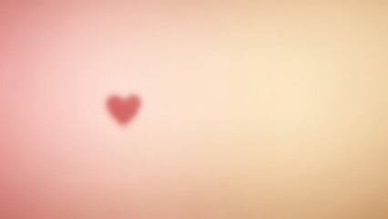 A small red heart on a blurred pink and orange background