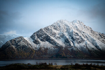 Snow-Covered Mountain Rising Above a Calm Fjord in Northern Norway