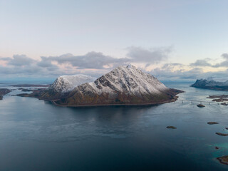Aerial View of a Snowy Mountain Island Surrounded by Fjords in Northern Norwaydefault