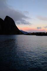 Calm Fjord at Dusk With Mountain Silhouette, Water Reflections, and Nordic Village