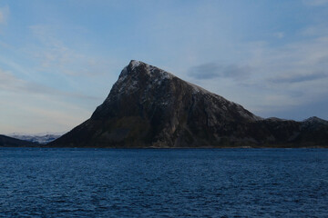 Dark Mountain Island Rising From the Sea Under a Calm Nordic Sky