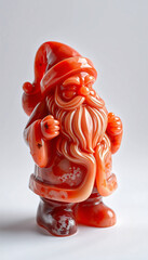 An antique ceramic angel statue sits beside a red rose and candle with scattered petals, creating a gold-toned religious art symbol of love and a decorative Christmas gift isolated on China