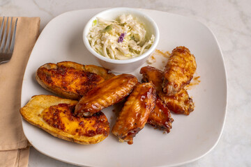 chicken wings with potato skins and cole slaw