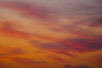 Soft pink sunset sky with delicate clouds and peaceful atmosphere