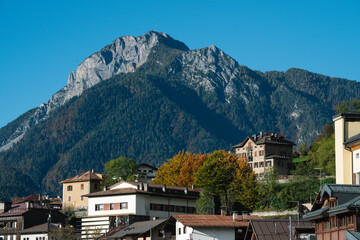 Fototapeta premium Valle di Cadore, Dolomites, Italy - Mountain Village scene in late summer early autumn fall with mountains and churches