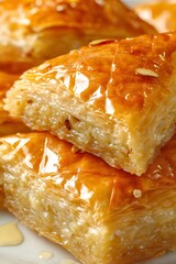 Baklava pieces with golden crispy phyllo dough and sweet honey syrup, traditional middle eastern dessert