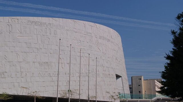 Facade of The Bibliotheca Alexandrina or Library of Alexandria, major library and cultural center on the Mediterranean shore in Alexandria, Egypt. Panning real-time footage
