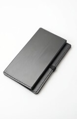 Minimalist black card holder case rests on white surface. Sleek accessory stores credit cards or business cards. Clean design for modern individuals needing to organize.