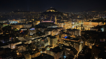 Fototapeta premium Aerial drone photo of illuminated festive Syntagma square featuring Greek Parliament and Christmas tree during New Year's Eve, Athens centre, Attica, Greece
