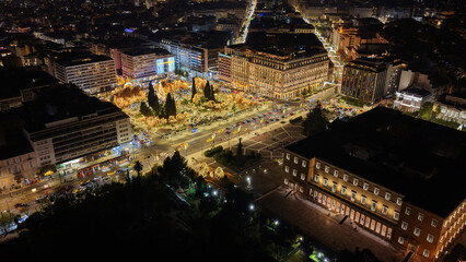 Fototapeta premium Aerial drone photo of illuminated festive Syntagma square featuring Greek Parliament and Christmas tree during New Year's Eve, Athens centre, Attica, Greece