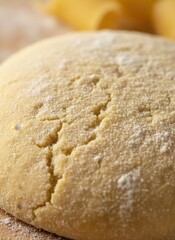Close Up Macro View of Fresh Raw Pasta Dough Dusted with Flour on a Wooden Surface with Blurred Pasta Rolls in Background
