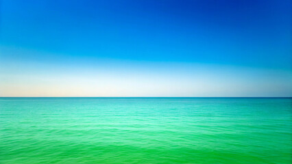 Fototapeta premium Tranquil Turquoise Ocean Water Meeting a Clear Blue Sky Horizon green Background