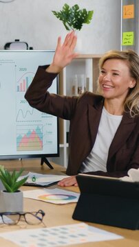 Business collaboration where businesswomen stacking hands one on one making gesture of unity and then giving high five each other in modern office