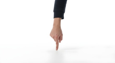 Person in athletic wear pointing downward against plain white background for fitness concept